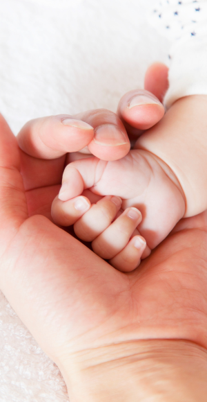 Dad holding baby hand