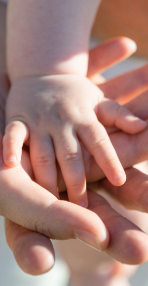 Baby hands on parents hands